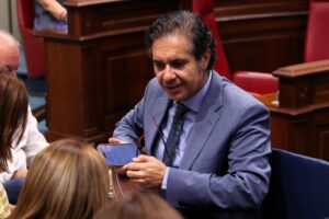 Jesús Ramos, portavoz adjunto del Grupo Parlamentario Agrupación Socialista Gomera (ASG) dialoga con otros diputados durante la sesión plenaria de la Cámara autonómica.